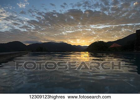 Stock Photograph - Sunlight reflected on the tranquil ocean water at sunset; Jalisco, Mexico. Fotosearch