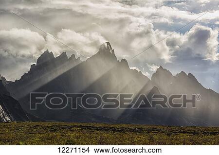 Sunlight streaks through rain and mist by Tombstone Mountain in Tombstone Territorial Park; Yukon, Canada View Large Photo Image Picture - Sunlight streaks through rain and mist by Tombstone Mountain in Tombstone Territorial Park; Yukon, Canada . Fotosearch