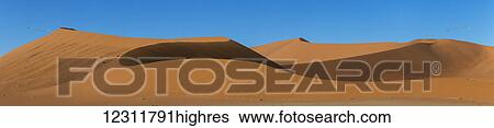 Sunrise light illuminates the large, red sand dunes in Sossusvlei which is part of the Namib desert; Namibia View Large Photo Image Stock Photograph - Sunrise light illuminates the large, red sand dunes in Sossusvlei which is part of the Namib desert; Namibia. Fotosearch