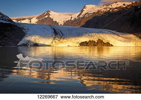 Stock Photo - Sunrise view of Portage Glacier with icebergs and Byron Peak in the background, Chugach National Forest, Kenai Peninsula, Southcentral Alaska, Summer.. Fotosearch