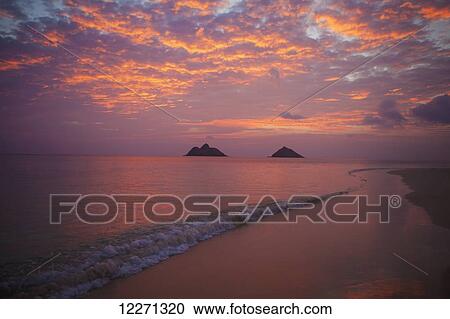 Stock Image - Sunset at Lanikai Beach, with Mokuluas islands in the background; Oahu, Hawaii, United States of America. Fotosearch