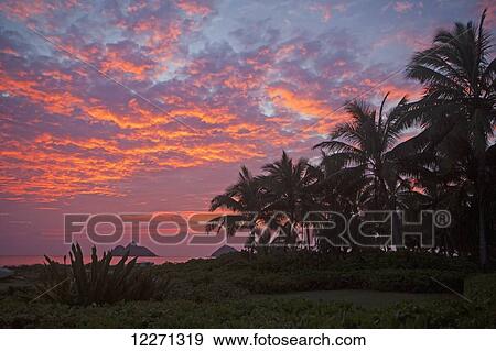 Stock Photo - Sunset at Lanikai Beach, with Mokuluas islands in the background; Oahu, Hawaii, United States of America. Fotosearch