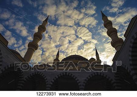Stock Image - Sunset over Ertogrul Ghazi mosque; Ashgabat, Turkmenistan. Fotosearch