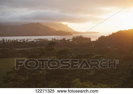 Sunset over Hanalei Bay and Haena (in distance) from Hanalei Valley lookout; Hanalei, Kauai, Hawaii, United States of America View Large Photo Image Stock Photography - Sunset over Hanalei Bay and Haena (in distance) from Hanalei Valley lookout; Hanalei, Kauai, Hawaii, United States of America. Fotosearch