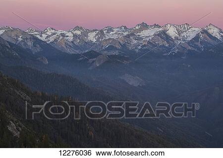 Stock Photograph - Sunset over Sierra Nevada range as seen from the Moro Rock in Sequoia National Park; California, United States. Fotosearch