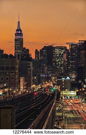 Picture - Sunset over Sunnyside, Queens with Empire State Building in background (colours celebrating New Years Eve); New York City, New York, United States of America. Fotosearch