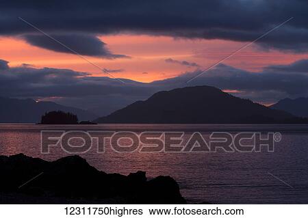 Stock Photograph - Sunset over the Pacific Ocean; Haida Gwaii, British Columbia, Canada. Fotosearch