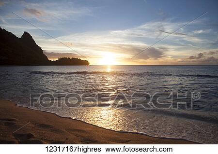 Stock Photograph - Sunset, Tunnels Beach, also known as Haena Beach, with view of Napali Coast, North Shore; Kauai, Hawaii, United States of America. Fotosearch