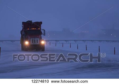 Stock Image - Supersucker truck driving on icy roads in the Prudhoe Bay Oil Field, Arctic Alaska, Winter. Fotosearch