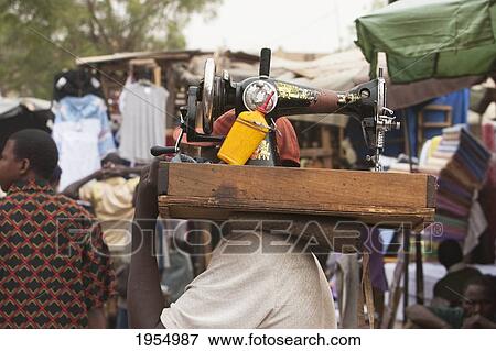Tailor carrying sewing machine in Bamako, Mali View Large Photo Image Stock Photo - Tailor carrying sewing machine in Bamako, Mali. Fotosearch