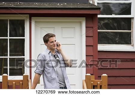 Teenage boy on a smart phone at the Knik Goose Bay Museum in Wasilla, Southcentral Alaska, Summer View Large Photo Image Stock Photo - Teenage boy on a smart phone at the Knik Goose Bay Museum in Wasilla, Southcentral Alaska, Summer. Fotosearch