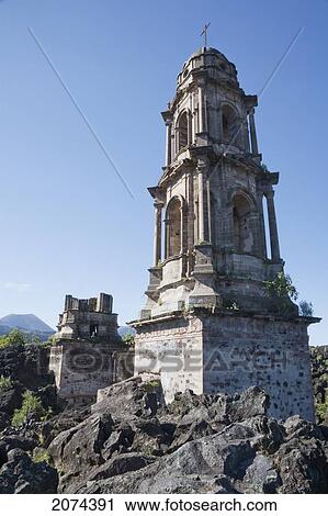 Stock Image - The Bell Tower Of The San Juan Parangaricutiro Church Sticks Out Through The Paricut. Fotosearch