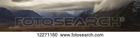Stock Image - The Blackstone Valley along the Dempster Highway is shrouded in clouds in autumn; Yukon, Canada. Fotosearch