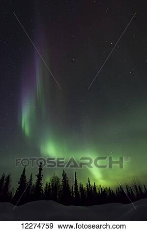 Stock Photo - The green glow of the Aurora Borealis Northern Lights) from the Petersville Road, Southcentral Alaska, Winter. Fotosearch
