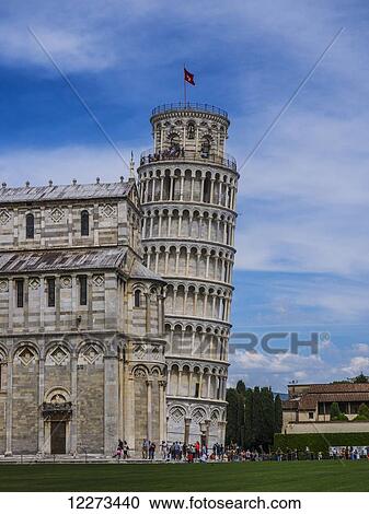 Stock Image - The Leaning Tower of Pisa peaks out from behind the Cathedral at the Piazza del Duomo; Pisa, Italy. Fotosearch