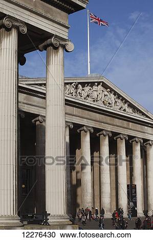 Stock Image - The neo-classical facade of the British Museum with the Union Jack flag flying; London, England. Fotosearch