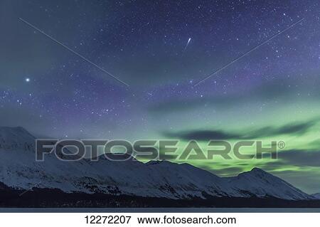 The Northern Lights and a meteor appear above the Kenai Mountains on Trail Lake, Moose Pass, Chugach National Forest, Southcentral Alaska, USA. View Large Photo Image Stock Photo - The Northern Lights and a meteor appear above the Kenai Mountains on Trail Lake, Moose Pass, Chugach National Forest, Southcentral Alaska, USA. . Fotosearch