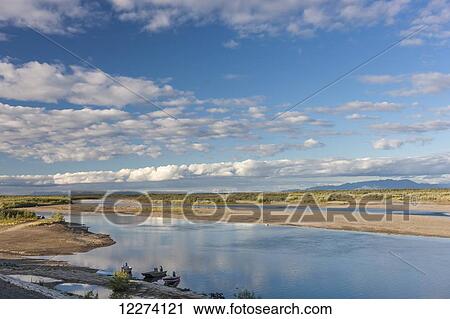Stock Image - The sandbars and channels of the Noatak River on a partly cloudy day, the Baird Mountains in the Background, Noatak, Arctic Alaska, USA, Summer. Fotosearch