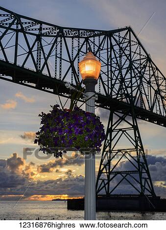 The sun sets at the Astoria-Megler Bridge; Astoria, Oregon, United States of America View Large Photo Image Stock Photograph - The sun sets at the Astoria-Megler Bridge; Astoria, Oregon, United States of America. Fotosearch