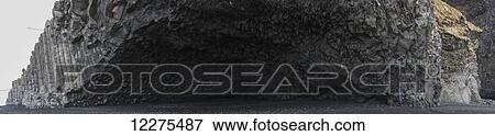 Stock Photo - The volcanic rocks along the southern shore of Iceland near the town of VIK, a cave carved into the rocks by the pounding surf; Iceland. Fotosearch