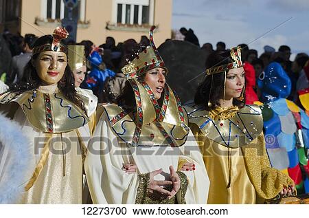 Stock Image - Three Egyptian ladies, Carnival parade; Fermo, Marche, Italy. Fotosearch