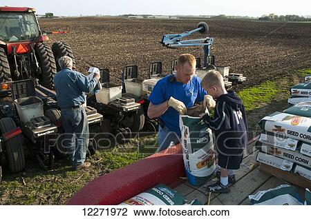 Three generations of family farmers loading their planter with corn seed in preparation for spring planting, near Northrop; Minnesota, United States of America View Large Photo Image Stock Image - Three generations of family farmers loading their planter with corn seed in preparation for spring planting, near Northrop; Minnesota, United States of America. Fotosearch