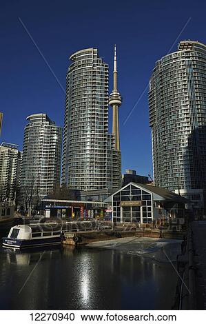 Stock Image - Tour boat moored at Queens Quay harbourfront coffee shop; Toronto, Ontario, Canada. Fotosearch