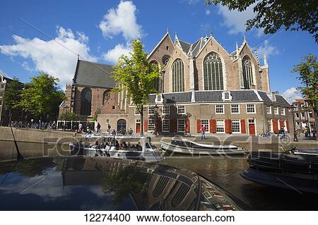 Tour boat on canal with the Old Church in the background; Amsterdam, Holland View Large Photo Image Stock Image - Tour boat on canal with the Old Church in the background; Amsterdam, Holland. Fotosearch