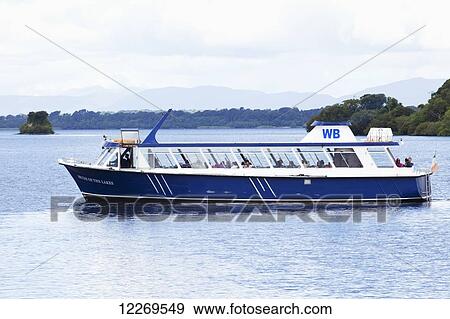 Stock Photo - Tour boat with passengers in a lake; Killarney, County Kerry, Ireland. Fotosearch