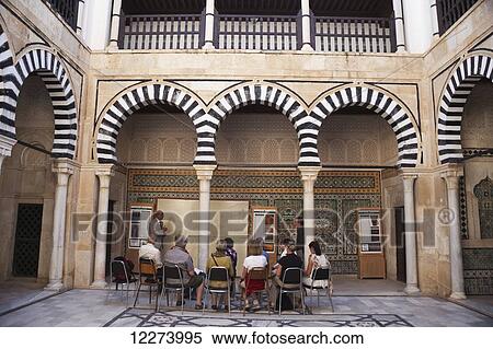 Stock Photography - Tour group in courtyard of Zaouia Sidi Abid Ghariani, The Medina; Kairouan, Tunisia. Fotosearch