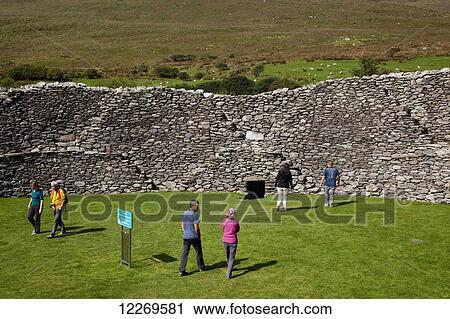 Stock Image - Tourists at the Staigue fort; County Kerry, Ireland. Fotosearch