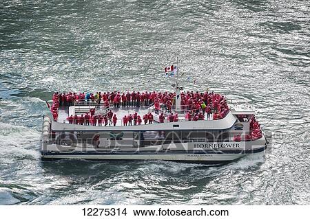 Picture - Tourists in red raincoats on the Hornblower tour boat; Niagara Falls, Ontario, Canada. Fotosearch