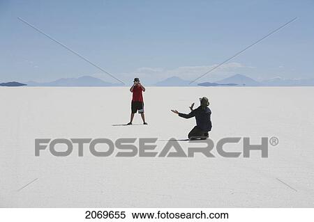 Tourists In The Salar De Uyuni, The World's Largest Salt Flat, Potosi Department, Bolivia View Large Photo Image Stock Photography - Tourists In The Salar De Uyuni, The World's Largest Salt Flat, Potosi Department, Bolivia. Fotosearch