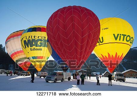 Stock Photo - Tourists watch as hot air balloons ready for lift-off during the ski resort's annual hot air balloon festival; Filzmoos, Austria. Fotosearch