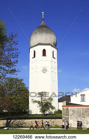 Stock Photograph - Tower with onion shaped dome and pedestrians along a path; Die Fraueninsel, Bayern, Germany. Fotosearch