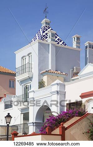 Stock Photography - Traditional architecture, lamppost and blue sky; El Porto de La Santa Maria, Andalusia, Spain. Fotosearch