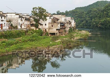 Tranquil river with houses along the water's edge in a small village near Wuyuan; Jiangxi province, China View Large Photo Image Stock Image - Tranquil river with houses along the water's edge in a small village near Wuyuan; Jiangxi province, China. Fotosearch