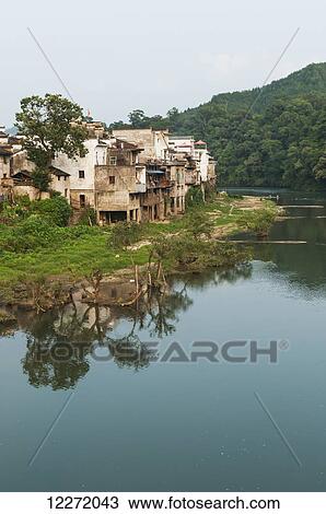 Tranquil river with houses along the water's edge in a small village near Wuyuan; Jiangxi province, China View Large Photo Image Stock Image - Tranquil river with houses along the water's edge in a small village near Wuyuan; Jiangxi province, China. Fotosearch