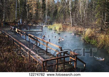 Stock Image - Travelers take a break at Liard River Hot Springs along the Alaska Highway, British Columbia, Canada. Fotosearch