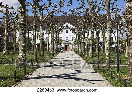 Trees line a walkway to a building; Die Herreninsel im Chiemsee, Bayern, Germany View Large Photo Image Stock Image - Trees line a walkway to a building; Die Herreninsel im Chiemsee, Bayern, Germany. Fotosearch
