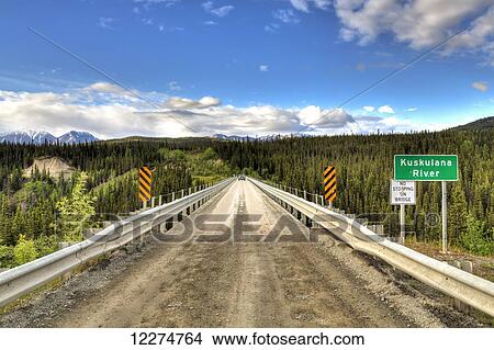 Truck driving across the Kuskulana River Bridge on the McCarthy Road in Wrangell-St. Elias National Park and Preserve, Southcentral Alaska, Spring, HDR View Large Photo Image Picture - Truck driving across the Kuskulana River Bridge on the McCarthy Road in Wrangell-St. Elias National Park and Preserve, Southcentral Alaska, Spring, HDR. Fotosearch