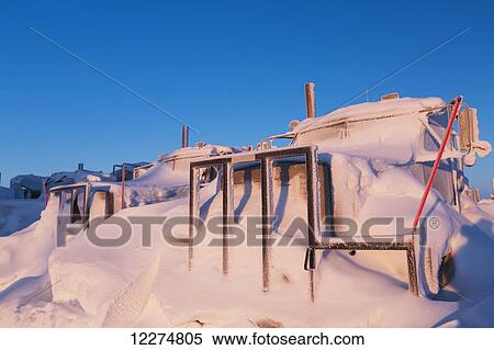 Stock Photography - Trucks covered in snow after a recent blizzard in the Prudhoe Bay Oilfield, North Slope, Arctic Alaska, Winter. Fotosearch