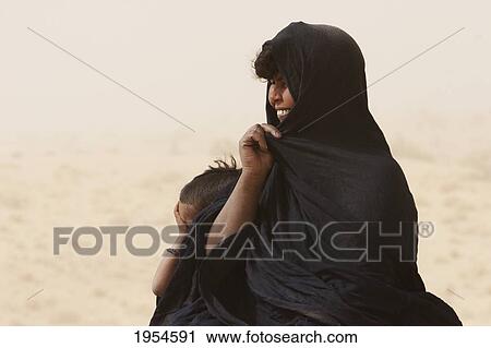 Tuareg woman on a sand dune near Timbuktu, Mali View Large Photo Image Stock Image - Tuareg woman on a sand dune near Timbuktu, Mali. Fotosearch