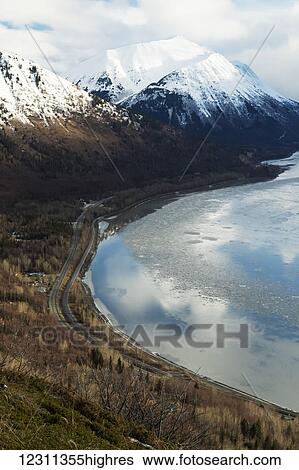 Turnagain Arm, surrounding mountains and Seward Highway shown from above, with Indian area seen on left side; Alaska, United States of America View Large Photo Image Stock Photograph - Turnagain Arm, surrounding mountains and Seward Highway shown from above, with Indian area seen on left side; Alaska, United States of America. Fotosearch
