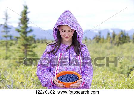Tween Inupiat eskimo girl in traditional native kuspuk dress holding blueberries, near Glennallen, Southcentral Alaska, Summer View Large Photo Image Stock Image - Tween Inupiat eskimo girl in traditional native kuspuk dress holding blueberries, near Glennallen, Southcentral Alaska, Summer. Fotosearch