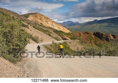 Two cyclist riding towards Polychrome Pass on the park road in Denali National Park, Interior Alaska, Summer View Large Photo Image Stock Photograph - Two cyclist riding towards Polychrome Pass on the park road in Denali National Park, Interior Alaska, Summer. Fotosearch