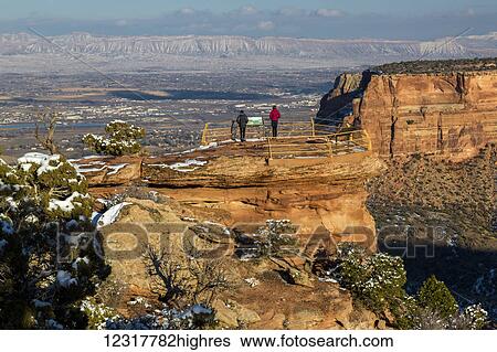 Stock Photograph - Two female tourists enjoy the views of the Colorado National Monument; Colorado, United States of America. Fotosearch