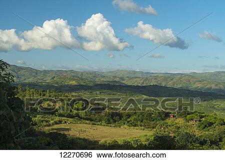 Stock Photograph - Two football matches simultaneously on patch of grass in hills above Chikwawa; Malawi. Fotosearch