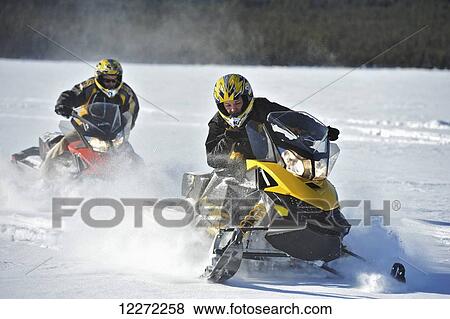 Two friends snowmachine through fresh snow on Little Harding Lake in Harding Lake State Recreation Area 45 miles south of Fairbanks in Interior Alaska. View Large Photo Image Stock Photo - Two friends snowmachine through fresh snow on Little Harding Lake in Harding Lake State Recreation Area 45 miles south of Fairbanks in Interior Alaska.. Fotosearch