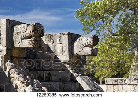 Two large Ancient Mayan stone carved Jaguar heads above stone steps to a platform with blue sky; Chichen Itza, Yucatan, Mexico View Large Photo Image Stock Photography - Two large Ancient Mayan stone carved Jaguar heads above stone steps to a platform with blue sky; Chichen Itza, Yucatan, Mexico. Fotosearch